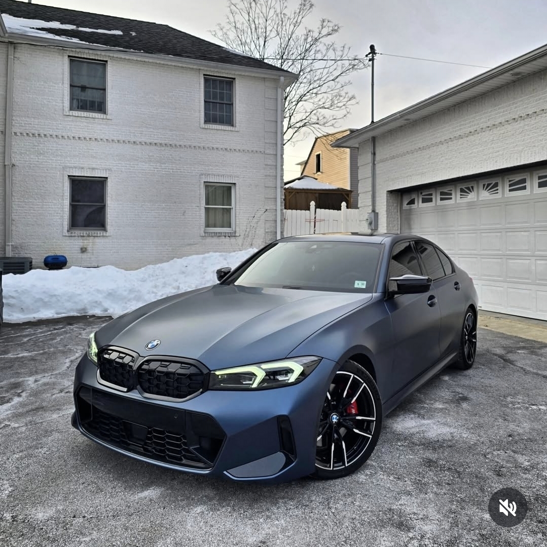 Dark blue BMW M340i with full body matte paint protection film in the snow